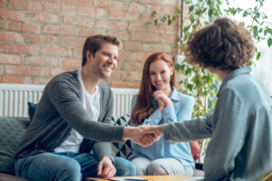 man-and-broker-shaking-hands-in-office-2024-10-18-03-36-10-utc